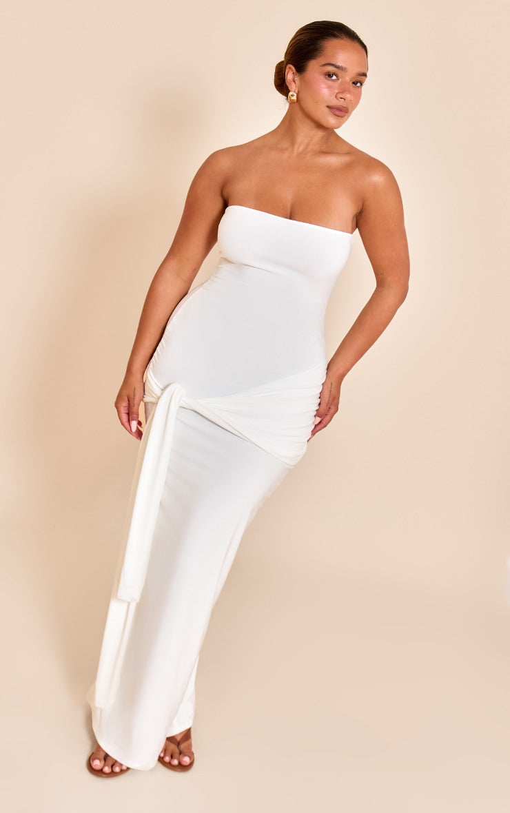 https://cdn-img.prettylittlething.com/1/d/f/1/1df10913591015b3c14a1e933cb830c177474cc6_CNN1860_1_shape_white_bandeau_wrap_tie_waist_maxi_dress.jpg