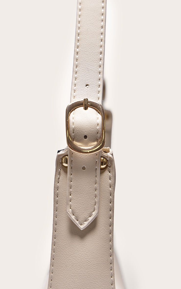 https://cdn-img.prettylittlething.com/5/b/1/b/5b1b4f42130976efcd94562812269842ea4d9cd4_CMS9383_4_cream_curved_pu_shoulder_bag.jpg