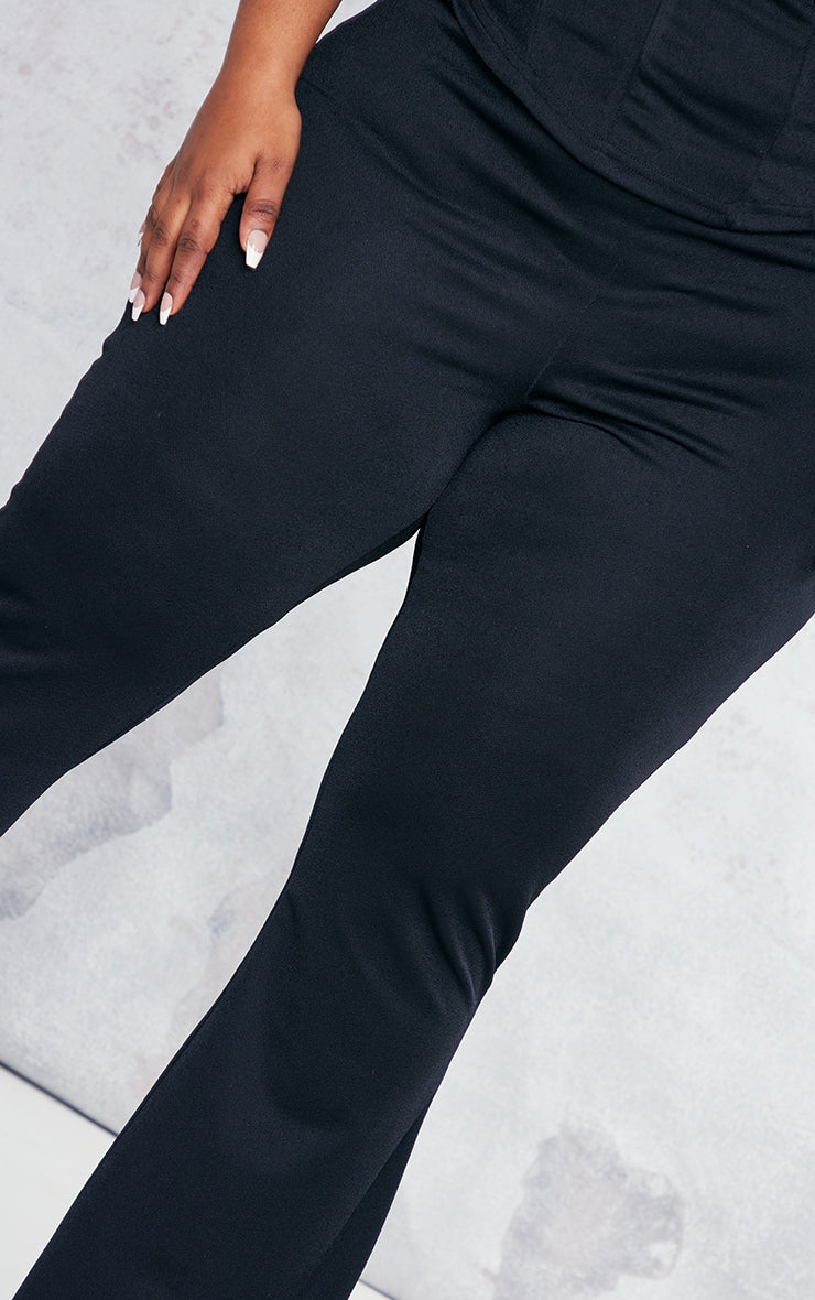 https://cdn-img.prettylittlething.com/c/d/e/8/cde8562c06bfc6fc0d3536343966bb7f5a158d71_CNC2188_4_plus_black_flare_leg_high_waisted_trousers.jpg