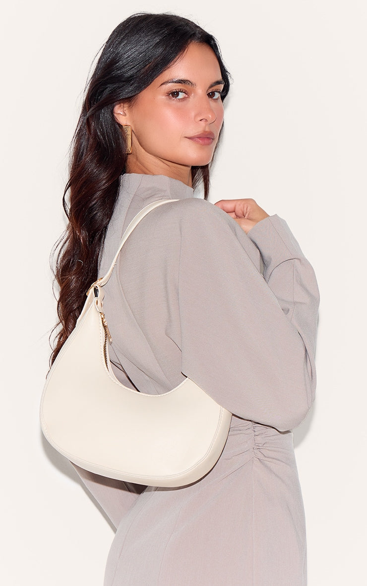 https://cdn-img.prettylittlething.com/d/2/a/c/d2ac067fbbbbdeec0da9174ffe60aba618ec944b_CMS9383_5_cream_curved_pu_shoulder_bag.jpg